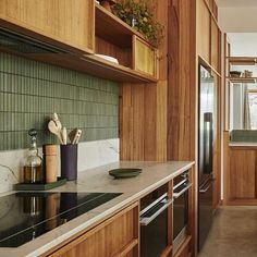 a kitchen with wooden cabinets and white counter tops