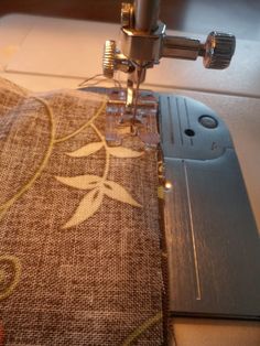 the sewing machine is working on the piece of fabric that has been sewn together