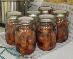 several jars filled with food sitting on top of a counter next to a pot and pan