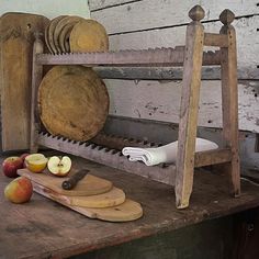 a wooden table topped with cutting boards and apples