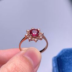 925 Sterling Silver Ring, Natural Garnet Red Stone Halo Ring, Ring for Women, Birthstone Ring for Women, Dainty Stackable Ring, Gift for Her. BASIC INFORMATION Gemstone: Natural Garnet Raw Stone Size: Round 6mm Dainty CZ Diamond (shining zircon). Side stones: Shining CZ diamond (cubic zircon). Band color: Silver--18K white gold plated sterling silver Rose Gold--18K rose gold plated sterling silver Gold -- 18K yellow gold plated sterling silver CUSTOM METALS Ring Size: From US #2 to US #15. Suppl Round Ruby Flower Promise Ring, Red Round Cluster Promise Ring, Red Ruby Cluster Ring, Rose Gold Ruby Cluster Ring With Gemstones, Red Ruby Gemstone Flower Ring, Red Ruby Flower Ring With Gemstone, Red Gemstone Flower Ring, Ruby Gemstone Flower Ring For Promise, Red Gemstone Cluster Ring