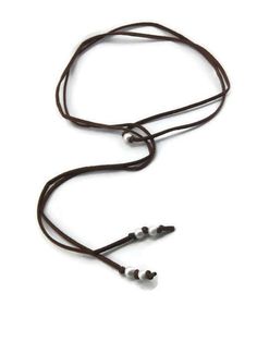 This lovely necklace features white freshwater pearls, strung onto a length of brown suede leather cord to create a boho style choker. The necklace itself measures just over 54 inches long. The long length of the suede cord makes this piece very versatile, wear it wrapped once, twice, or even three times as a choker, wear it tied as a long lariat or "Y" necklace, or even wrap it around your wrist to create a multistrand bracelet. The possibilities are limited only by your imagination. FUN FACT: Adjustable Brown Lariat Necklace For Festivals, Adjustable Brown Lariat Necklaces, Adjustable Brown Lariat Necklace, Brown Adjustable Lariat Necklace, Brown Lariat Necklace With Adjustable Length, Adjustable Brown Necklace With Waxed Cord, Adjustable Brown Necklace With Sliding Knot, Adjustable Brown Necklaces With Sliding Knot, Adjustable Brown Waxed Cord Necklace