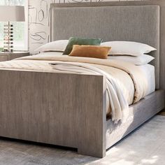 a bed that is in a room with a wooden headboard and foot board on it