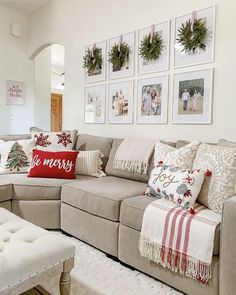 a living room filled with lots of furniture and pictures on the wall above it's couch