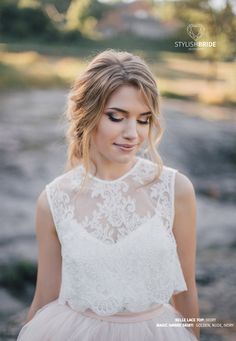 a woman wearing a white dress standing in the dirt