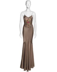 For Sale on 1stDibs - ▪ John Galliano bias-cut evening dress ▪ Taupe crepe-backed satin ▪ Floral embroidery at the front and back ▪ Floor-length skirt with train ▪ Silk trim Embroidered Silk Evening Gown, Embellished Satin Gown For Gala, Embroidered Satin Party Gown, Embellished Satin Evening Gown, Embroidered Satin Evening Dresses, Embellished Satin Maxi Gown, Elegant Embroidered Satin Dress, Embellished Fitted Satin Gown, Fitted Embellished Satin Gown