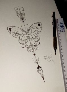 a drawing of a butterfly on paper next to a pen and ruler with writing underneath it