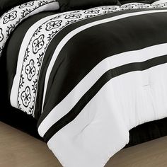 black and white comforter set on wooden floor in room