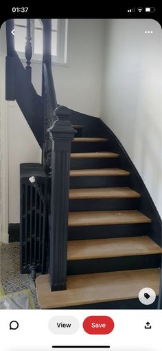 the stairs in this house are painted black and have wood treading on them,