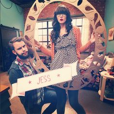 a man and woman standing in front of a mirror holding a sign that says jes