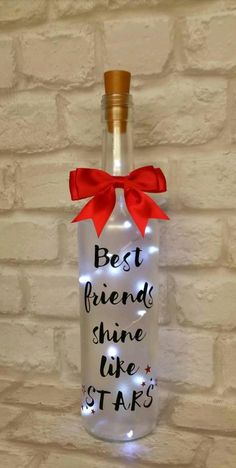 a lighted bottle with the words best friends shine like stars on it hanging from a brick wall