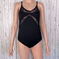 Jack Jet Black Bodysuit With Lace Cutouts In Front Cross Cross Spaghetti Straps With Low Backline V Neck Neckline. Mannequin Is A Size Small/Medium. Pit To Pit: 14” Middle Neckline To Crotch: 22.5” Hip To Hip: 15.5” Waistline: 13.5” Summer, Winter, Fall, Spring, Gothic, Essentials Stretch Cami Bodysuit For Party, Summer Stretch Camisole With Lined Body, Fitted Camisole With Lined Body For Loungewear, Summer V-neck Lined Camisole, Black Bodysuit With Built-in Bra For Spring, Summer Night Out Camisole Bodysuit, Night Out Camisole Bodysuit With Lined Body, Stretch Cami Bodysuit For Night Out, Camisole Bodysuit For Night Out With Lined Body