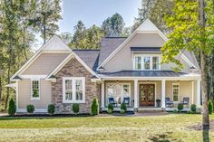 a house that is surrounded by trees and grass