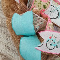 a close up of some fabric on a wooden floor with a bicycle and flower design