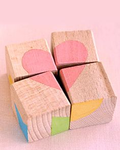 four wooden blocks with hearts on them