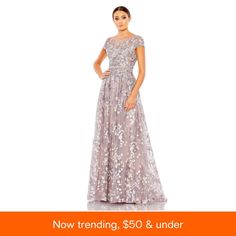 a woman in a dress with the words now trending, $ 50 & under