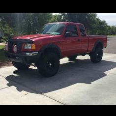 a red pick up truck parked on the street