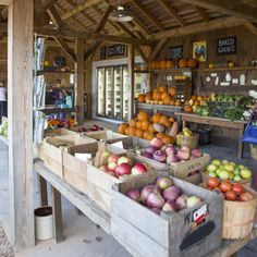 an outdoor market with lots of fruits and vegetables