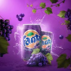 two cans of soda and some grapes on a purple background