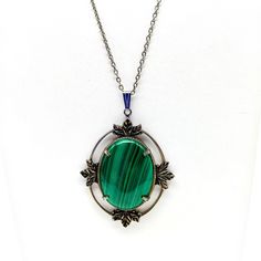 Malachite Look Green Pendant Necklace, Striped Lucite Vintage Cabochon in Silver Tone Ornate Leaf Frame on Silver Tone Chain Measurement * 24" chain; 3" x 2-1/4" pendant unsigned Condition * Very nice condition. Gently used. Size: Womens 24" Condition: Pre-Owned Good Vintage Handmade Necklaces With Oval Cabochon, Vintage Handmade Oval Cabochon Necklaces, Antique Oval Cabochon Gemstone Necklaces, Vintage Handmade Oval Cabochon Necklace, Ornate Oval Cabochon Necklaces, Vintage Gemstone Necklace With Oval Cabochon, Green Oval Cabochon Gemstone Necklace, Formal Green Locket Necklace, Green Cabochon Oval Pendant Necklace