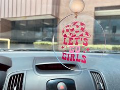 there is a car window with the words let's go girls on it in pink