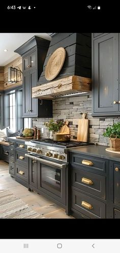 an image of a kitchen setting with black cabinets and gold pulls on the handles,