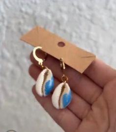 These shell earrings are an amazing beachy girl staple with its hand painted wave on a beachy cowri shell! Please keep in mind these can tarnish is worn in water so I would avoid it if possible! BOUGHT AND LOVE IT? Please write a review as it helps customers feel satiated purchasing!💓 Handmade Blue Summer Jewelry, Handmade Summer Blue Jewelry, Summer Ocean-inspired Shell-shaped Earrings, Handmade Ocean-inspired Earrings For Beach Season, Shell-shaped Beach Jewelry With Ear Wire, Shell-shaped Ear Wire Jewelry For Beach, Handmade Beachy Shell For Beach Season, Coastal Style Summer Shell Gift, Ocean-inspired Earrings For Beach Vacation