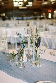 several vases filled with flowers on top of a table