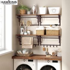 a washer and dryer in a room with shelves on the wall above them