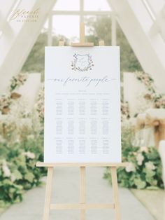 an easel with a wedding seating plan on it