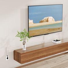 a flat screen tv mounted on the wall above a wooden entertainment center in a living room