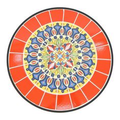 an orange and blue plate with designs on it's surface, isolated against a white background