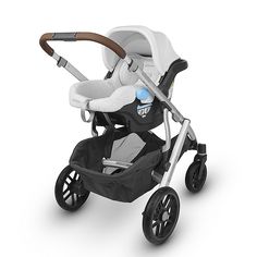 the stroller is white and has a brown handle