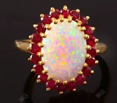 an opal and ruby ring set in yellow gold