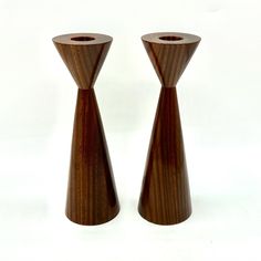 two wooden candlesticks sitting next to each other