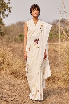 Off white saree featuring a floral print, crafted in cotton mul fabric. Paired with a schiffli embroidered blouse. - Aza Fashions White Floral Embroidered Chanderi Pre-draped Saree, Designer White Pre-draped Saree With Floral Embroidery, White Pre-draped Saree With Floral Embroidery For Festivals, White Blouse Piece With Printed Motifs For Diwali, White Cotton Silk Pre-draped Saree, White Blouse Piece With Printed Motifs In Traditional Drape, White Saree With Printed Motifs, White Saree With Printed Motifs For Navratri, White Wedding Blouse Piece With Printed Motifs