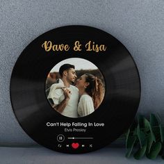 a personalized record with an image of a couple kissing and the words, can't help falling in love