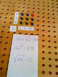 two pieces of paper with numbers on them and some magnets attached to the pegboard