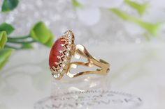 Coral Ring, Natural Orange Coral Stone Ring, gold red Jewelry, Genuine Coral Ring, Vintage Style Ring, and Gemstone Details of item: Metal: 24k gold plated (yellow or rose gold) or silver plated please choose in order Gemstone: coral 10*14 mm of stone and a little clear stones around the coral Adjustable ring The front of stone : 18 mm* 13 mm The ring will be packed in a gift box. Ready to ship 4-5 days, FOR MY CORAL RINGS HERE: https://www.etsy.com/il-en/shop/rebekajewelry?ref=hdr_shop_menu&amp Elegant Gold Crystal Ring With Cabochon, Elegant Gold Crystal Ring With Ruby, Gold Ruby Ring With Gemstone Accents, Gold Oval Rings With Gemstone Accents, Oval Jeweled Ring For Gift, Oval Jeweled Rings For Gifts, Oval Jeweled Rings Perfect For Gifts, Oval Gold Rings With Gemstone Accents, Gold Oval Cabochon Crystal Ring