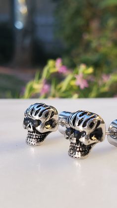 Description: Embrace a rebellious and edgy style with these Stainless Steel Black Cz Girls Biker Skull Stud Earrings. Crafted for those who love to make a statement, these earrings bring together toughness and glamour in a unique design. Product Features: Stainless Steel Construction: The earrings are made from durable stainless steel, ensuring longevity and resistance to tarnish. Black Cubic Zirconia Accents: The black cubic zirconia stones add a touch of darkness and sparkle, creating a bold and distinctive look. Biker Skull Design: The skull motif gives these earrings a rebellious and biker-inspired aesthetic, perfect for those with a daring sense of style. Stud Style: The stud design makes these earrings easy to wear daily, adding a hint of attitude to your look. Versatile Accessory: W Edgy Nickel-free Skull Earrings, Biker Style Skull Jewelry, Edgy Skull-shaped Pierced Earrings, Skull Print Gothic Jewelry For Streetwear, Edgy Pierced Skull Jewelry, Black Skull Print Jewelry For Streetwear, Black Skull-shaped Earrings With Skull Print, Silver Rocker Jewelry With Studs, Edgy Silver Jewelry For Biker Events