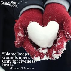 a heart - shaped snowball in the palm of someone's hands