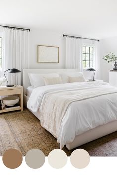 a bedroom with white bedding and neutrals in the color scheme, along with two windows