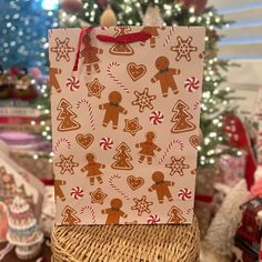 a paper bag with gingerbreads and christmas cookies on it