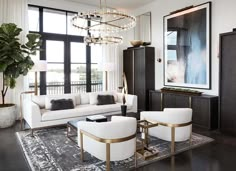 a living room filled with furniture and a chandelier