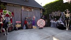 halloween decorations are on display in front of a house with skeleton figures and skeletons outside