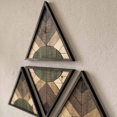 three triangular stained glass pieces hanging on the wall