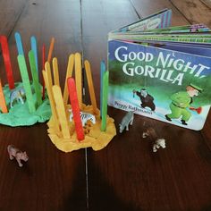 several children's books and toy animals on a table with the book good night, gorillaia