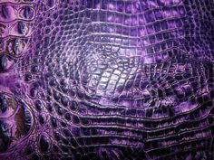 an alligator skin texture is shown in this close up photo, with purple hues