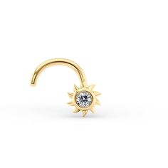 a gold nose ring with a diamond in the middle and a small sun on top