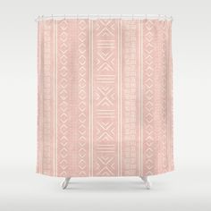 a pink and white shower curtain with an abstract design on the front, featuring geometric shapes